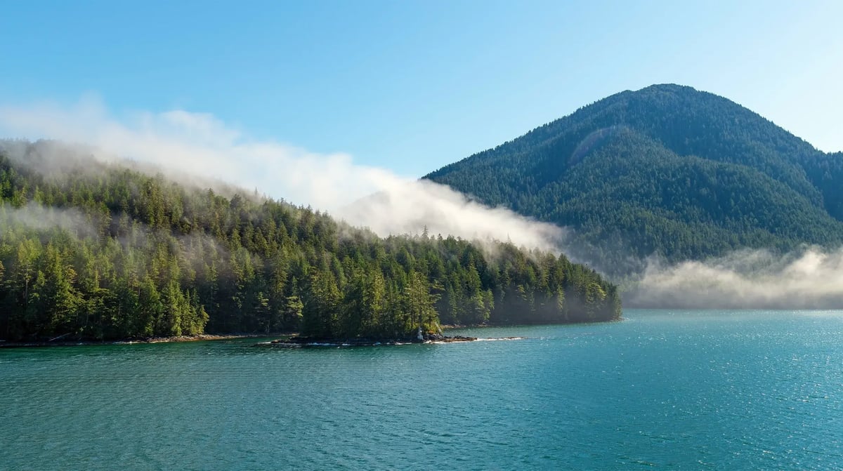 Panorama landscape of islands with pine and cedar trees forest in mist along Inside Passage cruise between Prince Rupert and Port Hardy, Vancouver